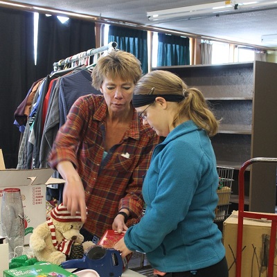 STEP job coach trains a thrift store employee.