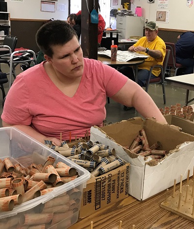 A worker sorts Coin-Tainers on-site at STEP Browerville.